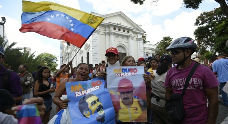 Supporters of Venezuelan President Nicolas Maduro demonstrate outside the National Assembly in Caracas on October 23, 2016