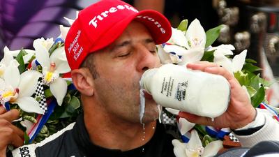 Driver Tony Kanaan of Brazil takes the traditional drink of milk after winning the 97th running of the Indianapolis 500 at the Indianapolis Motor Speedway.Jeff Haynes/Reuters