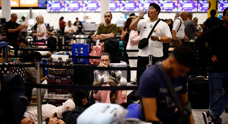 Passengers wait in the check in area of Gatwick Airport as some flights are cancelled or delayed caused by IT outages.BENJAMIN CREMEL/ Getty Images