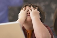 Frustrated Schoolboy with Laptop