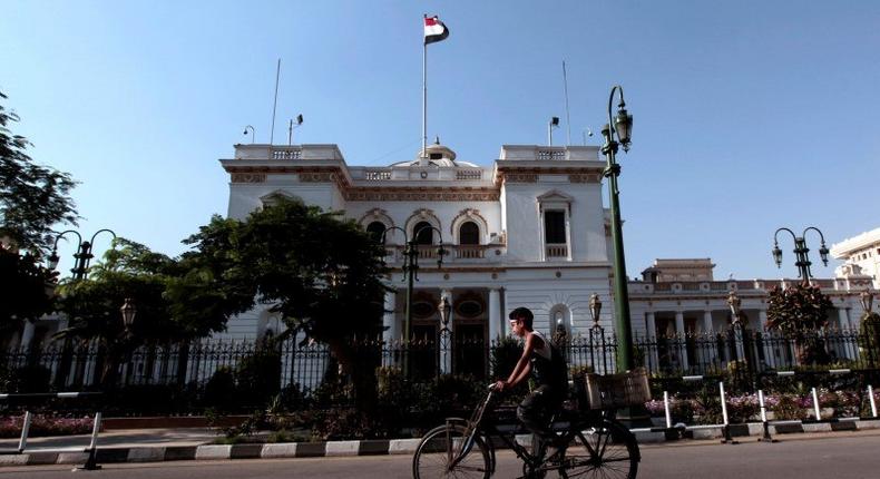 A boy rides a bike in front of the parliament building in Cairo, June 14, 2012. REUTERS/Mohamed Abd El-Ghany