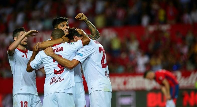 Sevilla's Franco Vazquez (C) celebrates with teammates after scoring a goal during the Spanish league football match against CA Osasuna on May 20, 2017