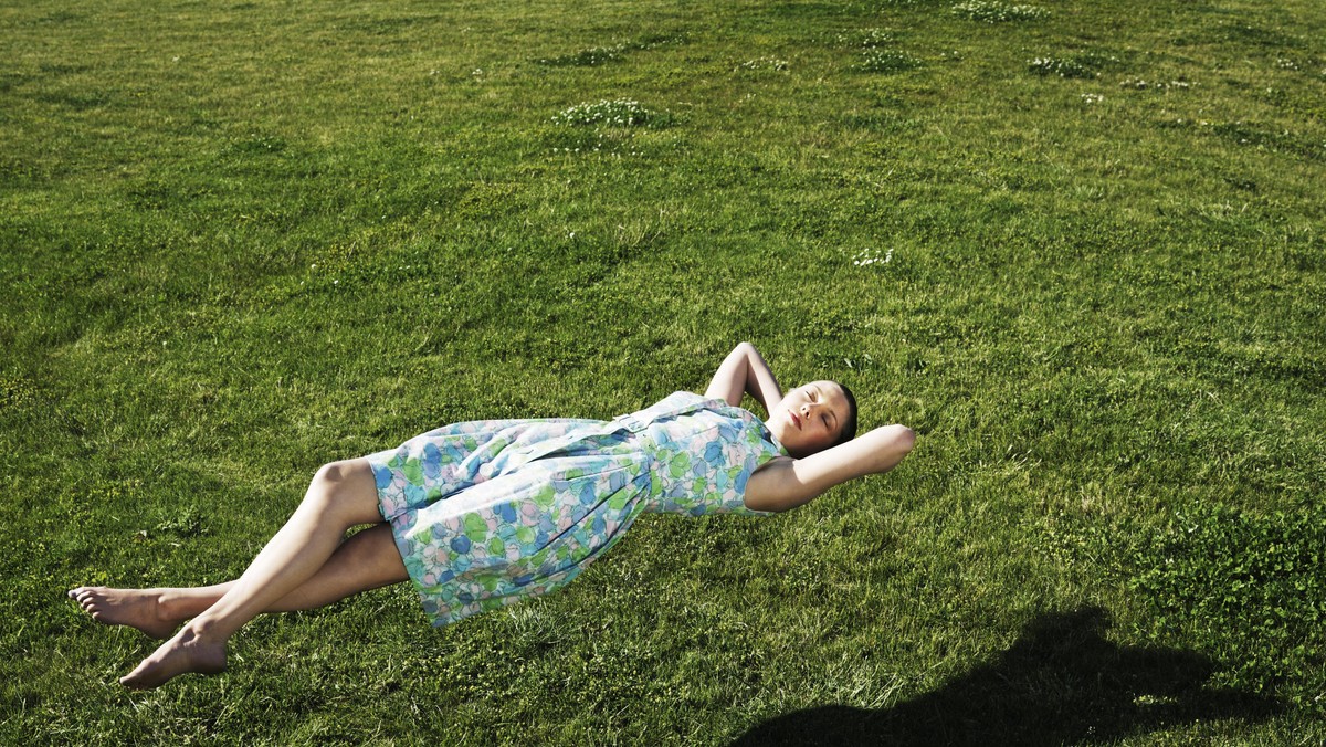 Woman realxing floating above the grass