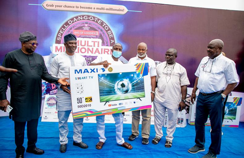 Mr Tunde Mabogunje, Regional Director, South West, Dangote Cement presenting a smart HD TV to Biliaminu Atlo Kehinde (who had also won 1million naira) with guests.