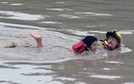 San Marcos Firefighter Jay Horton rescues a woman from in flood waters in San Marcos Texas