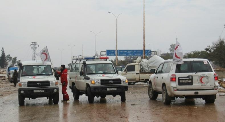 Staff of the Syrian Red Crescent wait on a road in December 2016 for evacuees from Fuaa and Kafraya, two Shiite-majority villages in northwestern Syria that are under siege by the Sunni Muslim rebels