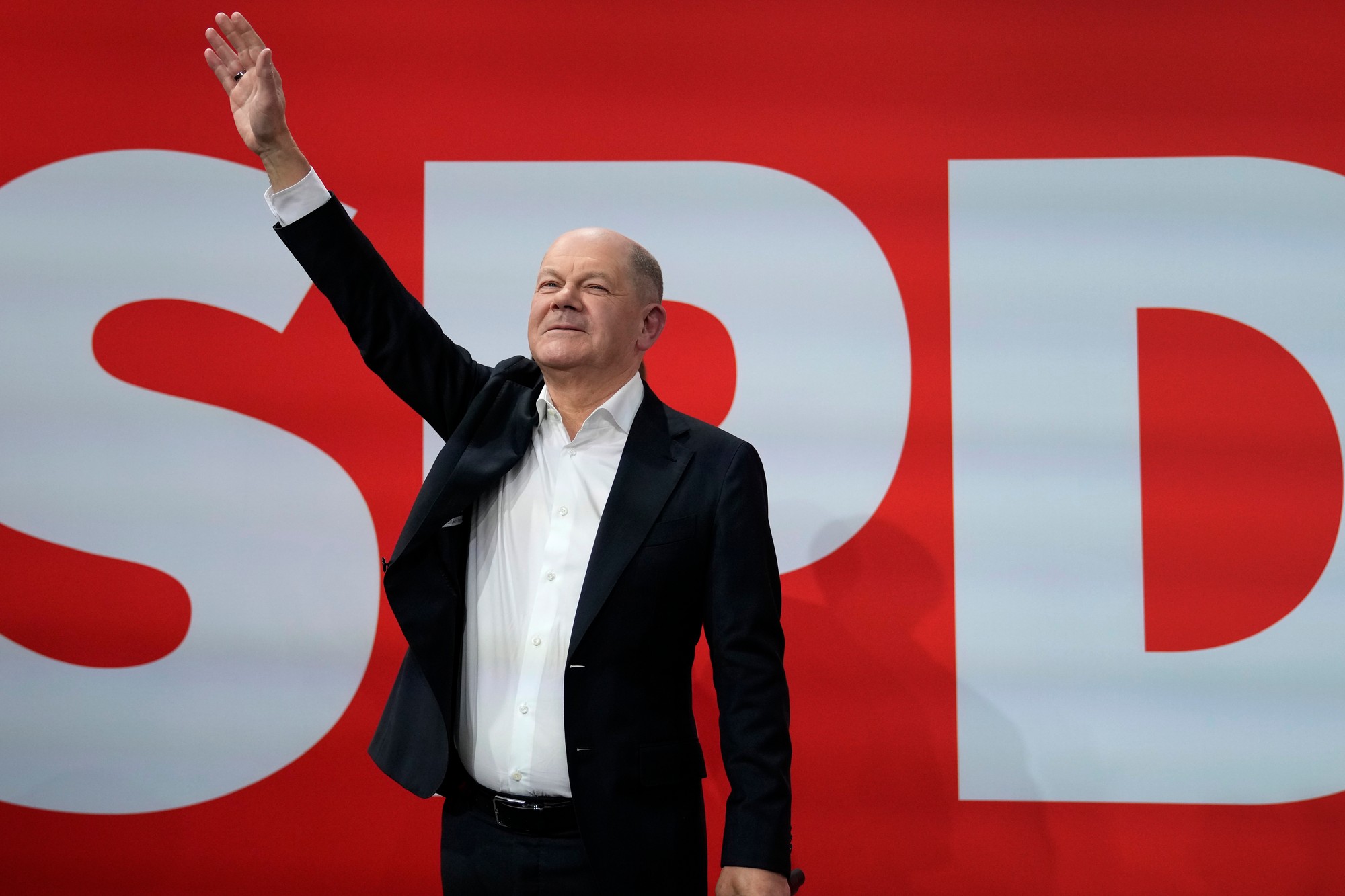 Nemecký kancelár Olaf Scholz máva po zverejnení prvých výsledkov exit pollov v sídle Sociálnodemokratickej strany Nemecka (SPD).