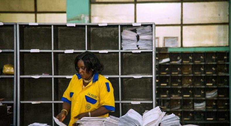 An employee distributes letters and other mail at a branch of the Congolese Company for Posts and Telecommunications in Kinshasa