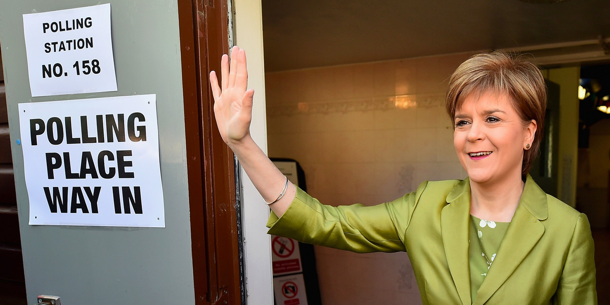 First Minister of Scotland and leader of the SNP Nicola Sturgeon, votes with her husband Peter Murrell on May 7, 2015 in Glasgow, Scotland.