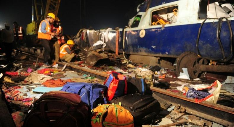 Rescue workers search for survivors in the wreckage of a derailed train near Pukhrayan in Kanpur district, northern India on November 20, 2016