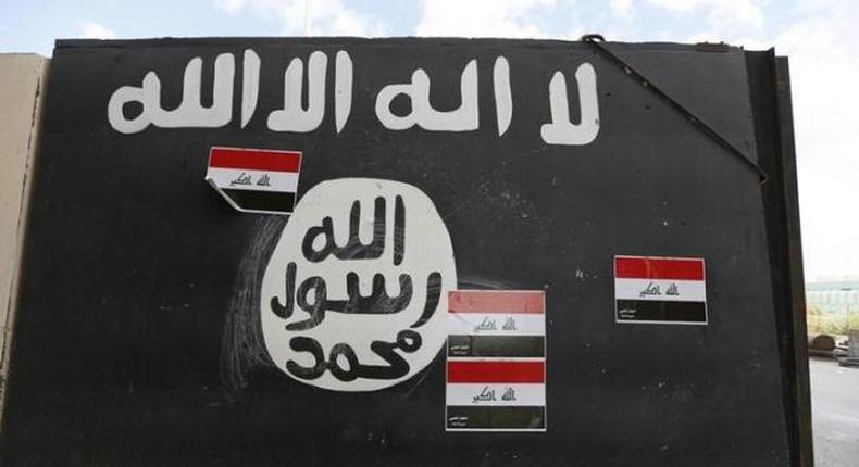 A wall painted with the black flag commonly used by Islamic State militants, near former Iraqi president Saddam Hussein's palace in Tikrit April 1, 2015.