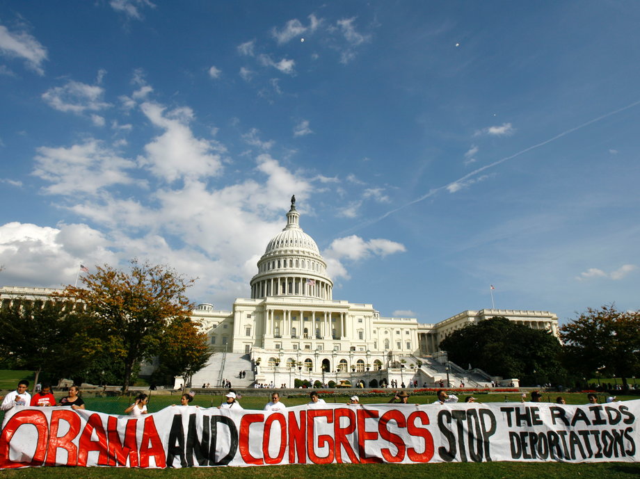 Latin American demonstrators hold up a banner against U.S. immigration raids and deportations during an immigration reform rally in front of the U.S. Capitol on Capitol Hill in Washington Oct. 13, 2009.