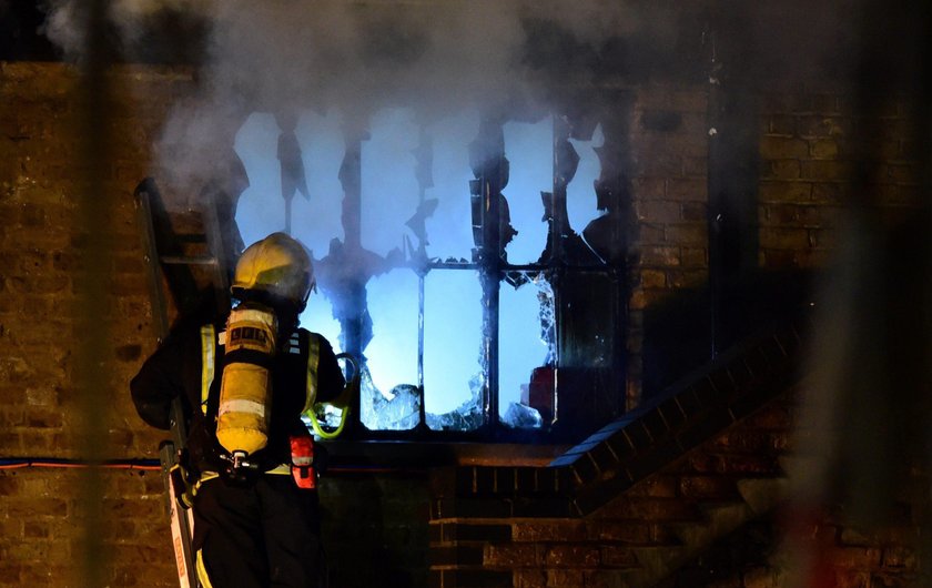 Firefighters spray water onto a fire at Camden Market in London