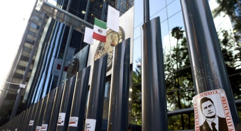 Stickers with the image of Mexican President Enrique Pena Nieto are stuck on columns outside the building of the attorney general's office during a protest against alleged government spying on journalists and human rights defenders in Mexico City last month