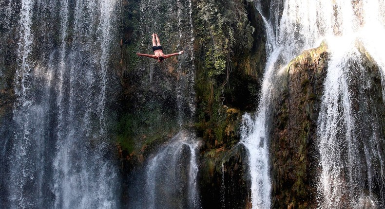 A competitor in the annual international waterfall-jumping competition held in the old town of Jajce, Bosnia and Herzegovina.