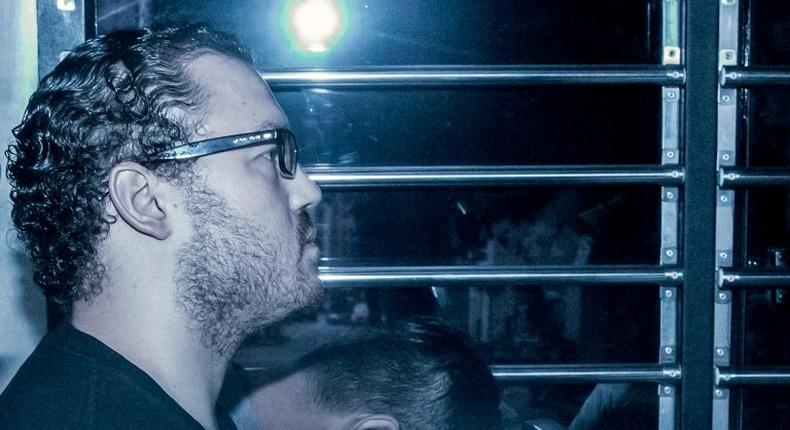 British banker Rurik Jutting sits in a prison van as he arrives at a Hong Kong court for a hearing in May 2015