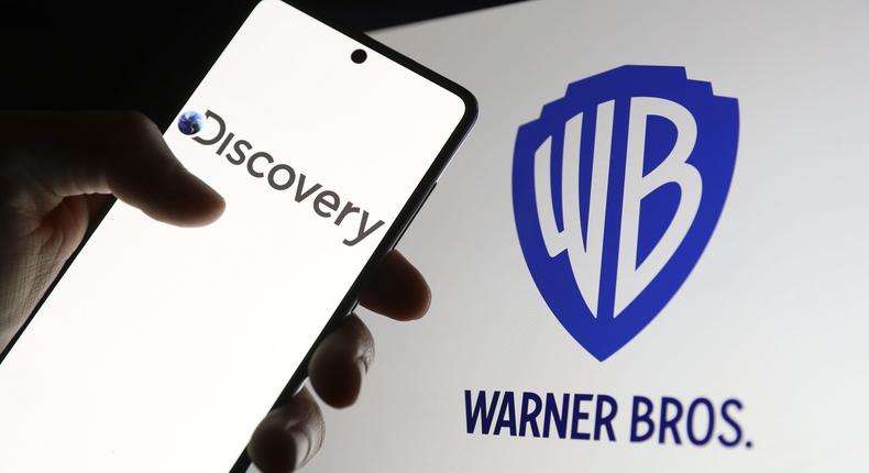 In this photo illustration the logo of Warner Bros is displayed on computer screen and the logo of Discovery is displayed on phone screen in front of it in.Celal Gunes/Anadolu Agency via Getty Images