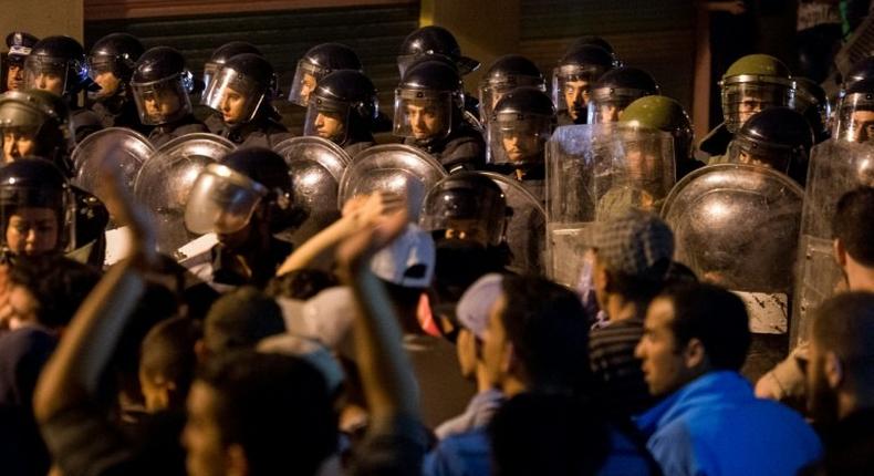 Police face protesters during a night demonstration in Morocco's Al-Hoceima on June 9, 2017