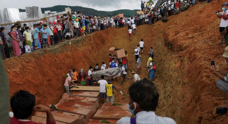A digger sealed the grave with earth, with many victims yet to be identified