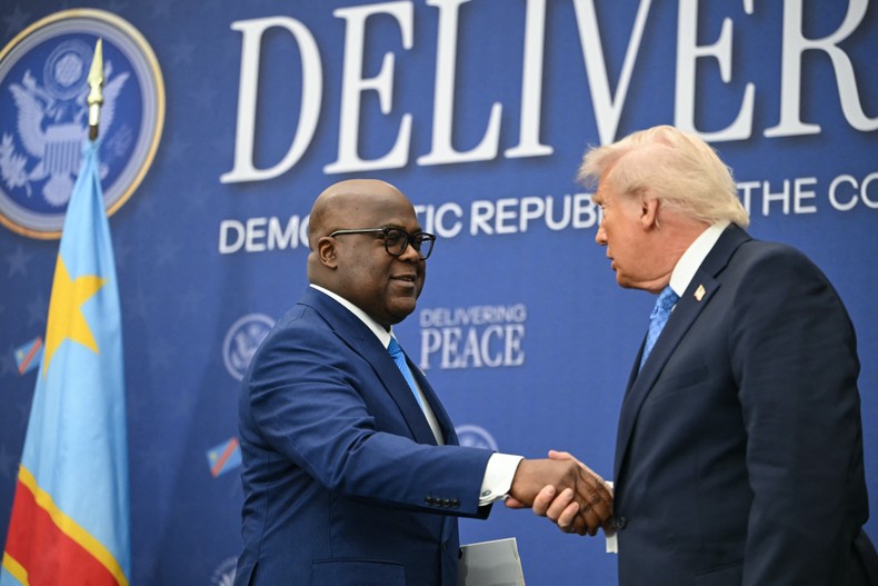 US President Donald Trump shakes hands with the President of the Democratic Republic of the Congo Felix Tshisekedi (L) during signing ceremony of a peace deal between Rwanda and the Democratic Republic of the Congo at the United States Institute of Peace in Washington, DC, on December 4, 2025. [Photo by ANDREW CABALLERO-REYNOLDS / AFP via Getty Images]