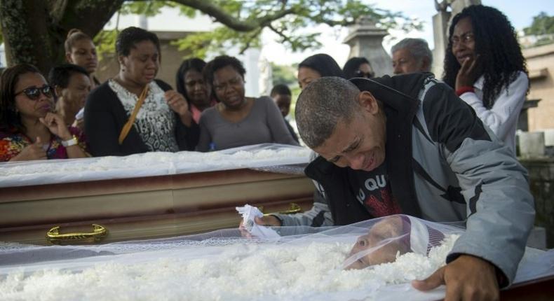 Luis Carlos de Oliveira, 49, mourns his relatives Ana Cristina da Conceicao, 42, and her mother, Marlene Maria da Conceicao, 76, killed by stray bullets during a firefight between police and traffickers in the Mangueira shantytown, in Rio de Janeiro in July 2017