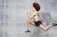 Woman jumping in air in urban studio