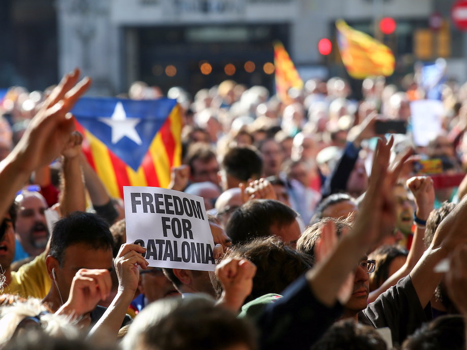 Protesters gather outside the Catalonian government buildings in Barcelona after Spanish paramilitary police arrested officials.