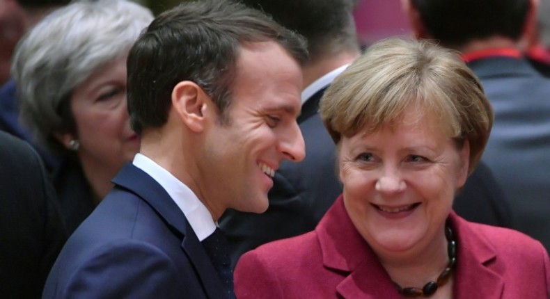 France's President Emmanuel Macron (L) talks with Germany's Chancellor Angela Merkel want to strengthen ties betweeen their two countries