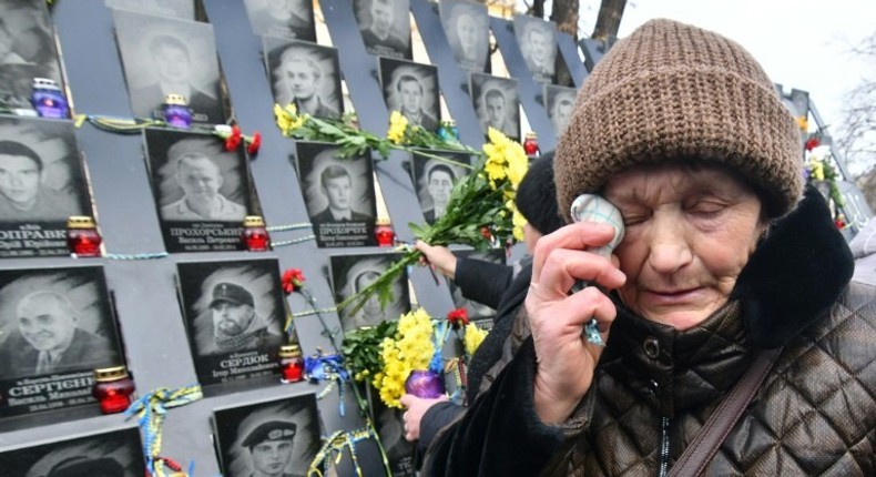 A woman cries at a memorial for the Heavenly Hundred who died during protests in Kiev's Maidan Square five years ago