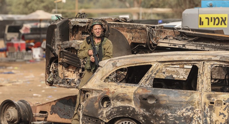 An Israeli solider stands at the grounds of the Supernova electronic music festival after Saturday's deadly attack by Hamas militants.Ilia Yefimovich/picture alliance via Getty Images