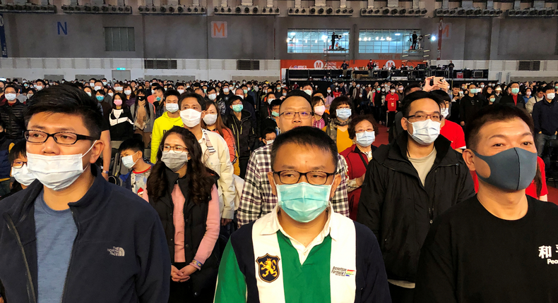 FILE PHOTO: Foxconn employees wearing masks attend the company's year-end gala in Taipei, Taiwan January 22, 2020. REUTERS/Yimou Lee/File Photo