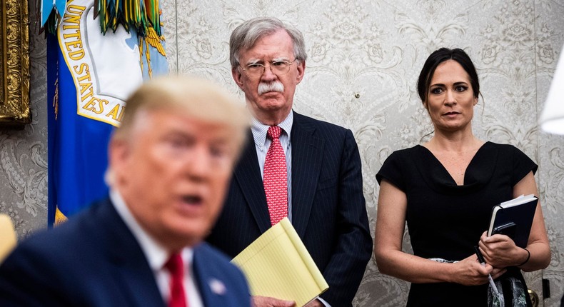 National Security Advisor John R. Bolton and White House Press Secretary Stephanie Grisham listen as President Donald J. Trump participates in a meeting at the White House on July 9, 2019.
