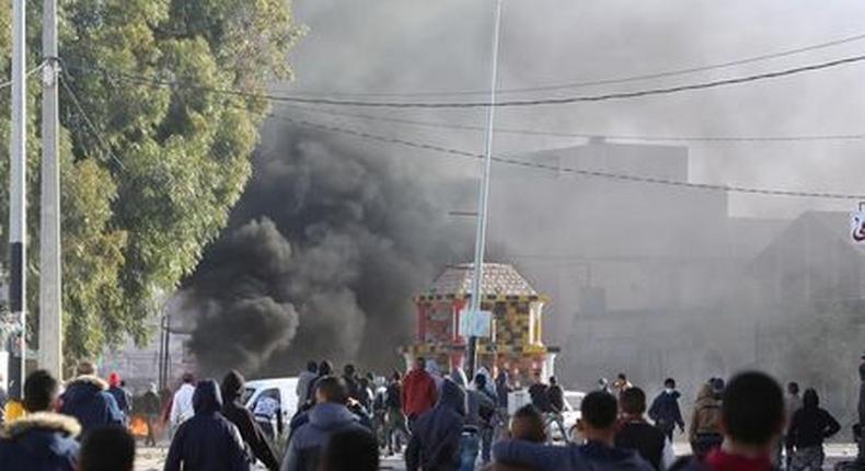 Protesters clash with riot police officers during a protest over jobs and a lack of development