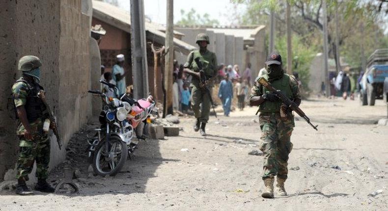 Nigerian soldiers comb a Borno town.