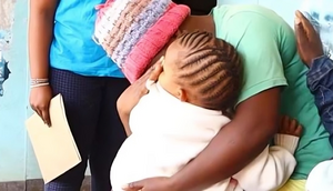 Beth Waithera embraces her baby [Citizen Digital]