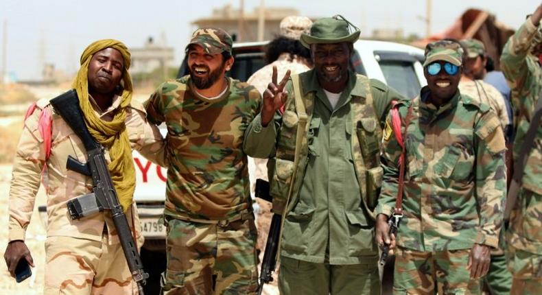 Libyan pro-government forces pose for a photo as they patrol on the outskirts of the eastern coastal city of Benghazi 