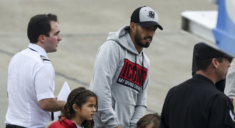 Barcelona player Luis Suarez (C) arrives with his family at the Santa Fe Province airport in Rosario, Argentina for his teammate Lionel Messi's wedding