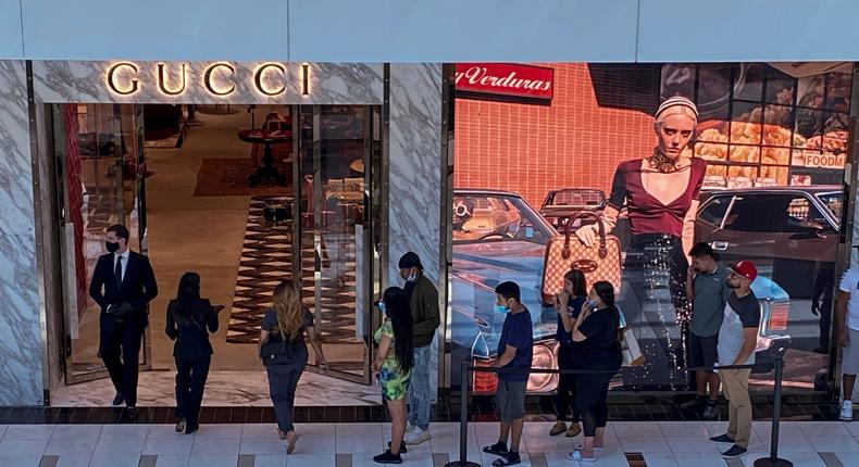 FILE PHOTO: Customers line up to enter a Gucci fashion store at the The Galleria shopping mall after the mall opened during the coronavirus disease (COVID -19) outbreak in Houston Texas, U.S., May 1, 2020. REUTERS/Adrees Latif