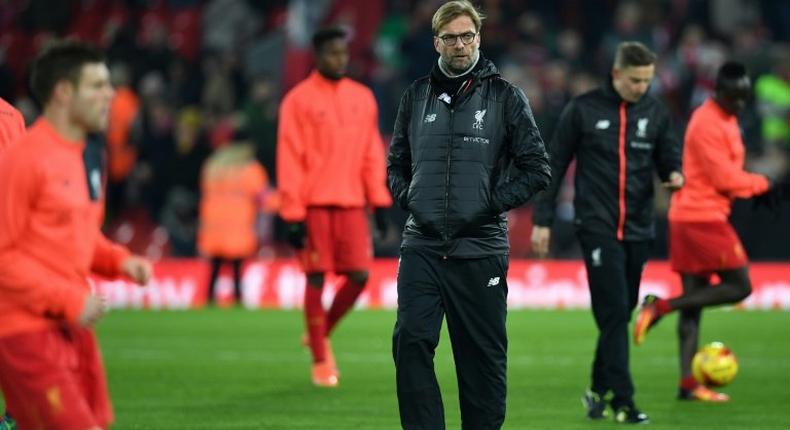 Liverpool's German manager Jurgen Klopp watches his players warm up at Anfield in Liverpool, north west England