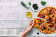 colorful tasty pizza. woman taking piece of italian pizza