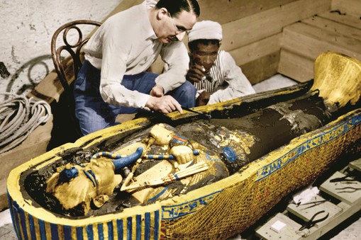 Howard Carter (1873-1939) english egyptologist near golden sarcophagus of Tutankhamon (mummy) in Egy