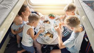 A family of four eating their meals.timltv/Getty Images