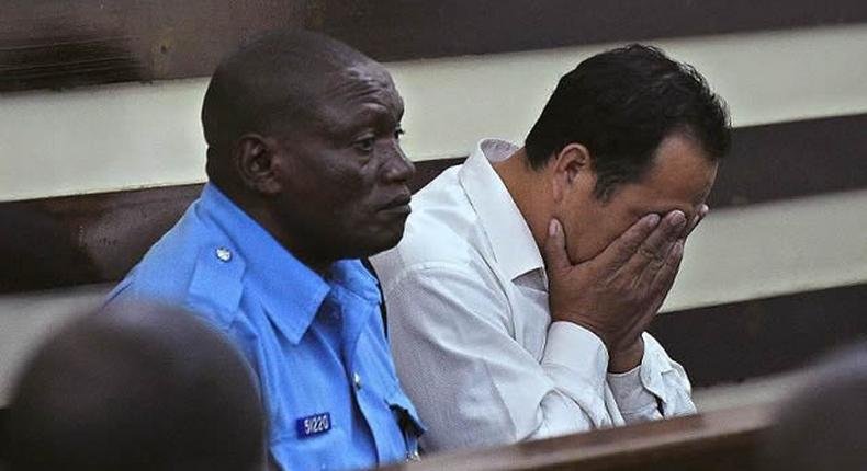 A Chinese national arraigned in court accompanied by a Kenyan police officer (Twitter)