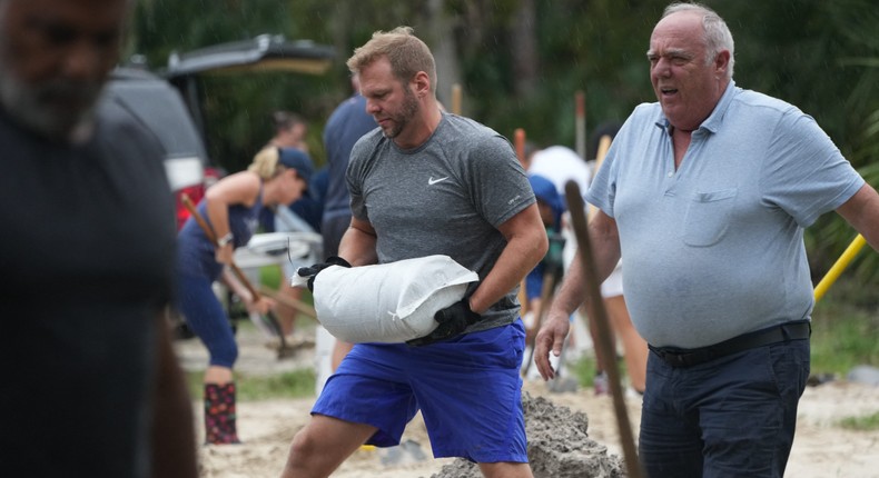 Residents in Palm Harbor, Florida, fill sandbags as Hurricane Milton approaches. Officials have warned homeowners along the state's west coast to evacuate.Bryan R. SMITH / AFP / Getty Images