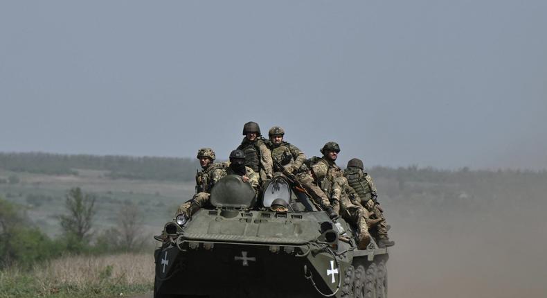 Ukrainian servicemen ride on an armored personnel carrier (APC) in a field near Chasiv Yar, Donetsk region, on April 27, 2024, amid the Russian invasion of Ukraine.GENYA SAVILOV/AFP via Getty Images