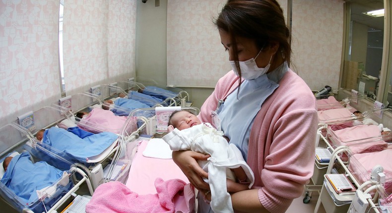 Hospital staff attend to newborn babies in Misato City in Japan.Yamaguchi Haruyoshi/Corbis via Getty Images