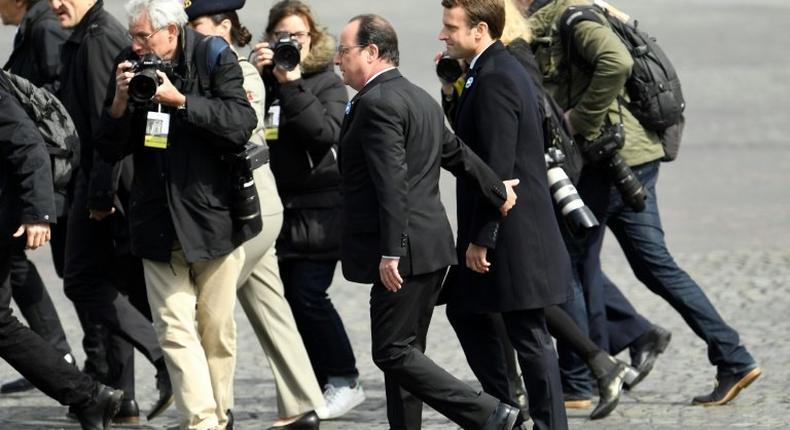 French President Francois Hollande walks with president-elect Emmanuel Macron at a ceremony marking the 72nd anniversary of the victory over Nazi Germany during World War II