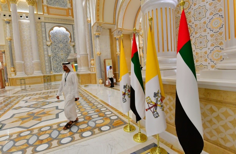 Vatican and Emirati flags stand in the UAE's presidential palace during the visit of Pope Francis