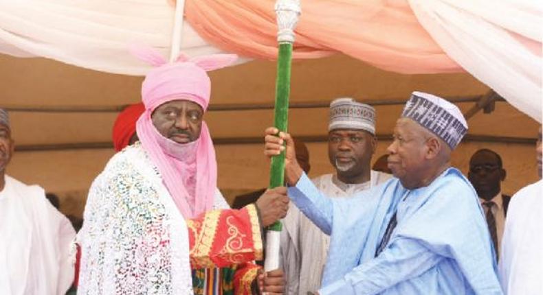 An illustrative image of Kano State Governor, Abdullahi Ganduje presenting the staff of office to Alhaji Aminu Ado Bayero. [Daily Trust]