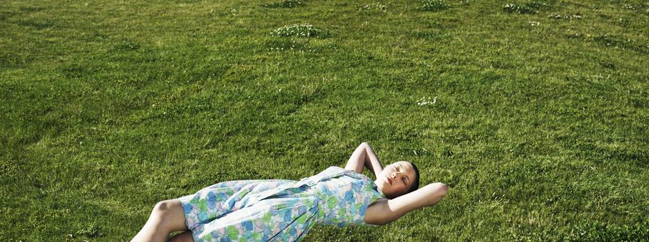 Woman realxing floating above the grass